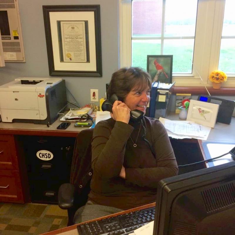 Amy Gooding is at the desk when you enter Cape Henlopen High School. She is there to listen, but has sports stories to tell. DAVE FREDERICK PHOTO